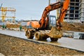 Big bright yellow powerful industrial heavy excavator tractor, bulldozer, specialized construction equipment for road repair Royalty Free Stock Photo