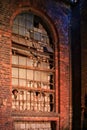 Big, broken and walled window in an old factory building