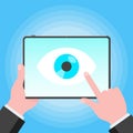 Big brother concept. Hands holding stablet pc spying with big eye on the screen isolated on light blue background