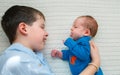 Big brother hugging his newborn baby girl. Toddler kid meeting new sibling Royalty Free Stock Photo