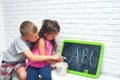 Big Brother Teaches Sister to Write Letters in Summer Holidays