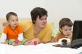 Big brother watching cartoons with his younger sisters at laptop Royalty Free Stock Photo