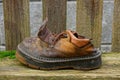 Old ragged brown shoe on a gray board