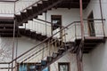 Big brown staircase on a gray building wall with windows and a door Royalty Free Stock Photo