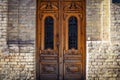 Big brown wood antique door in brick wall building