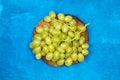 A big bunch of green grapes on a tree trunk Royalty Free Stock Photo