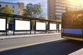 Big bus stop in a modern city with blank advertising banners inside