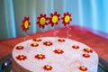 Big cake decorated with berries and flowers with a first birthday candle Royalty Free Stock Photo