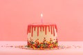 Big cake with one candle. Happy birthday candles. Cake with red chocolate decoration on pink background. Bright candles Royalty Free Stock Photo