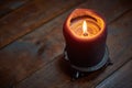 Big candle on wooden table