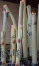 Big candles with glowing flame in Sanctuary of Lourdes. Burning candles. Faith and prayer concept. Religious symbol.