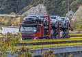 An automotive car carrier truck driving down the highway with a full load of new vehicles. Royalty Free Stock Photo