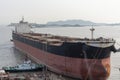 Big cargo ship entering dry dock for scheduled maintenance and painting. Royalty Free Stock Photo