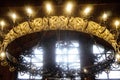 Big chandelier on the ceiling in Russian Orthodox Church with crucifix and electric lamps