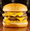 Big cheeseburger with melted cheese and glittery b Royalty Free Stock Photo