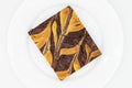 Big Chocolate Brownie with a Cheesecake Swirl on a White Plate Royalty Free Stock Photo