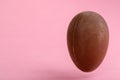 chocolate Easter egg on pink background with copy space funny creative concept Royalty Free Stock Photo