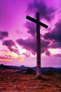 Big Christian cross standing on top of a hill Radobyl in CHKO Ceske Stredohori area at evening after sunset in czech summer land