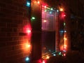 Big Christmas lights surround a window