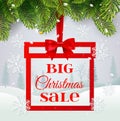 Big Christmas sale, banner gift shape with gold ribbon and bow, on winter landscape background and christmas tree with Royalty Free Stock Photo