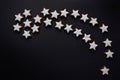 A big Christmas star made of many little biscuits in star shape, against a dark background with space for text Royalty Free Stock Photo