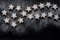 A big Christmas star made of many little biscuits in star shape, against a dark background with space for text Royalty Free Stock Photo