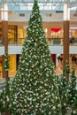 The big christmas tree in a shopping mall. Bright Christmas tree with colorful garlands and balls in a shopping center Royalty Free Stock Photo