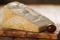 Big chunk of italian parmesan cheese on wooden cutting board Royalty Free Stock Photo