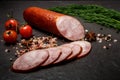 big chunk of smoked ham sausage with dill and tomatoes Royalty Free Stock Photo