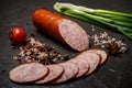 Big chunk of smoked ham sausage with green onions and tomato Royalty Free Stock Photo