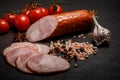 Big chunk of smoked ham sausage with tomatoes and garlic Royalty Free Stock Photo