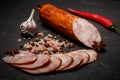 Big chunk of tasty ham sausage with garlic and chili pepper Royalty Free Stock Photo