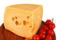 Big chunk of yellow cheese and tomatoes Royalty Free Stock Photo