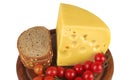 Big chunk of yellow cheese with tomatoes and bread Royalty Free Stock Photo