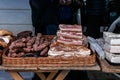 Big chunks of fresh salted bacon and cured sausage on a village market stall. Royalty Free Stock Photo
