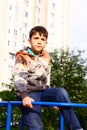 Big city boy in the yard playground Royalty Free Stock Photo