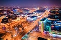 Big city lights shining bright along main street, aerial view