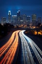 big city skyline and traffic lights blurred motion, skyscrapers and highway light trails at rush hour Royalty Free Stock Photo