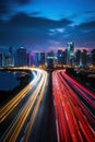 big city skyline and traffic lights blurred motion, skyscrapers and highway light trails at rush hour Royalty Free Stock Photo