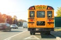 Big classic vintage american yellow schoolbus standing on a bus lane at highway and waiting pupils and children for