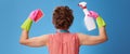 Woman with sponge and a bottle of detergent showing biceps Royalty Free Stock Photo