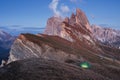 Big cliff. Green tent standing on the hill. Awesome place in the alpes of Seceda