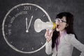 Big clock with businesswoman using megaphone Royalty Free Stock Photo