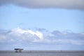 Big clouds and blue sky along the Suffolk coast at Sizewell inlet outlet cooling water tower pier