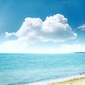 Clouds in blue sky over sea and sand Royalty Free Stock Photo