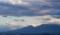Big clouds over the Apennine mountains at dusk in a blue spring sky