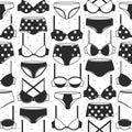 Women`s bras and panties. Black and white decorative background. Seamless pattern with lady`s lingerie