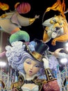 Big colorful giant papier mache figures at night in Fallas festival of Valencia. Sculpture of ninots colorful. Woman in circus