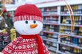 Big colorful toy Christmas snowman in the wine department