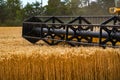 Big combine harvesting the wheat. Yellow wheat harvester in the field. Royalty Free Stock Photo